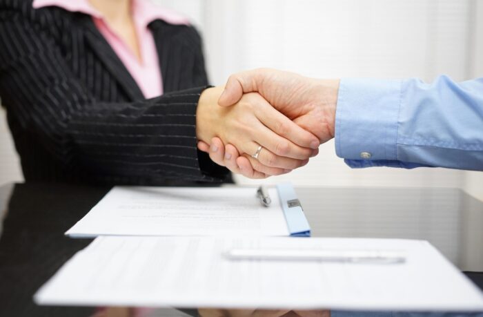 Attorney and client are handshaking.