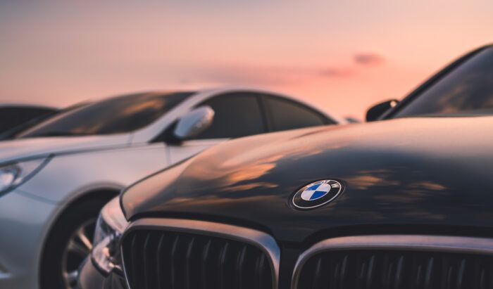 BMW car under a sunset sky.