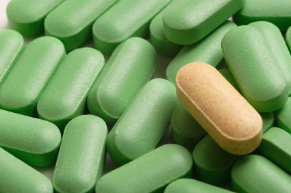 A yellow caplet amongst green