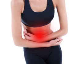 Woman suffering from abdominal pain isolated on white