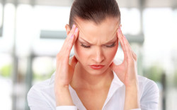 Young woman suffering a headache over white background