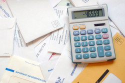 Bills and calculator showing a negative balance