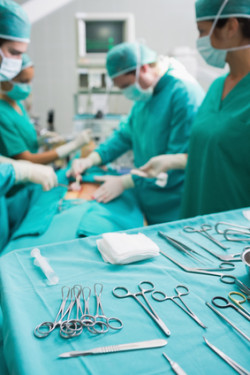 Surgical tools displayed on a surgical tray while surgeons are operating in a hospital