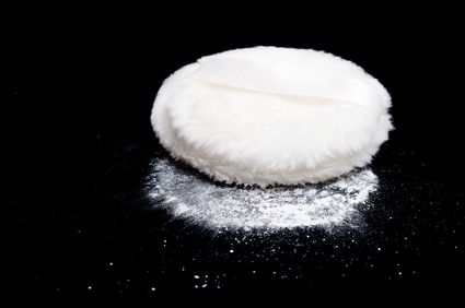 Talcum Powder Puff on a Black Background