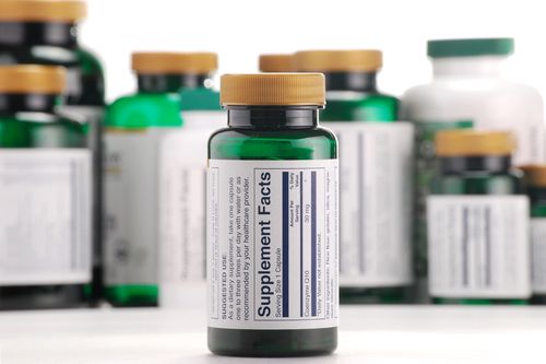 Composition with dietary supplement capsules and containers