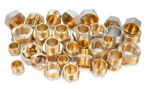 many metal fittings - pipe unions, bushings, bullnoses and nuts