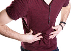 Man holding his stomach because of the pain