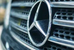 front of Mercedes vehicle displaying the company symbol