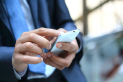 older man on smartphone using Tinder dating app