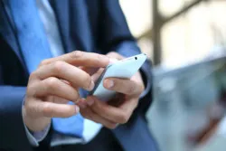 older man on smartphone using Tinder dating app