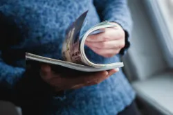 man reading magazine