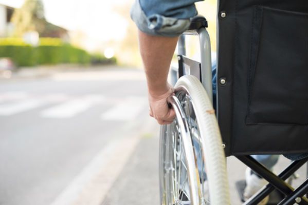 hand with hand on wheelchair