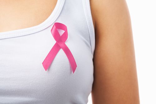 breast cancer survivor wears pink ribbon