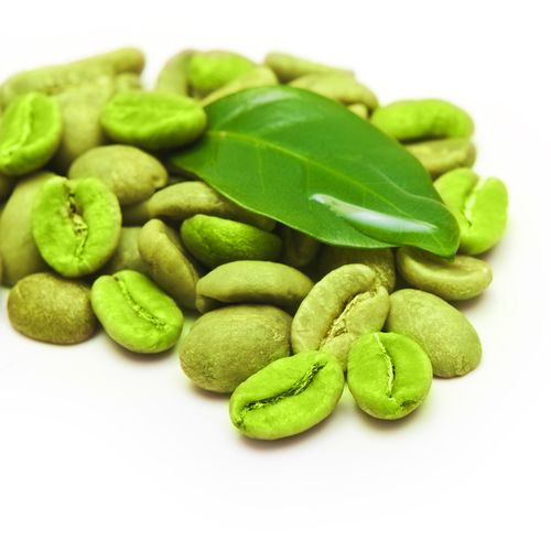 Green coffee beans with leaf on white background.
