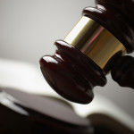 Juridical concept with hammer and lawbook, selective focus on metal part,toned f/x