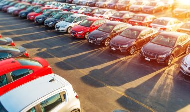 Dealer New Cars Stock. Colorful Brand New Compact Vehicles For Sale Awaiting on the Dealer Parking Lot. Car Market Business Concept.