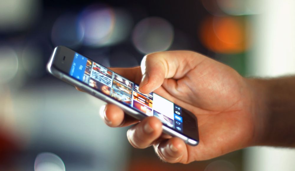 Business Man using Mobile Phone in Office