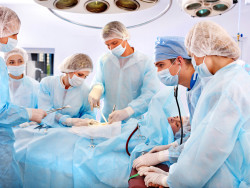 Team surgeon at work in operating room.