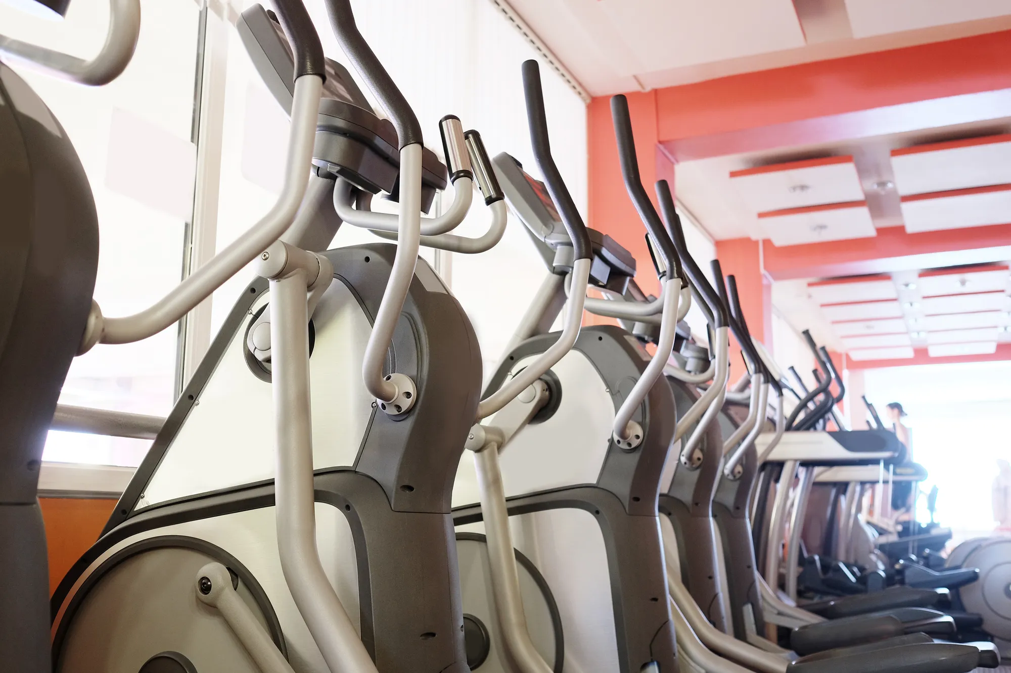 Elliptical cross trainer in a row in a gym