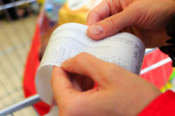 hand holding credit card receipt