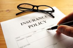 insurance policy form on desk in office showing risk concept