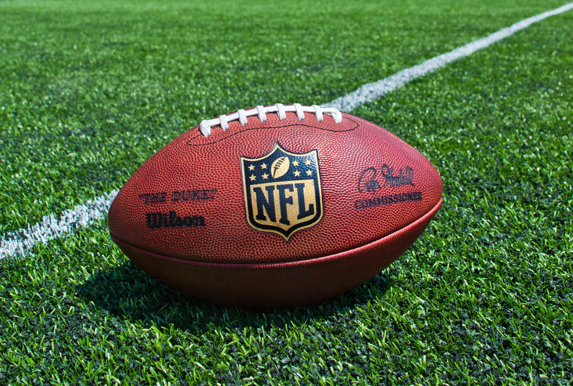ZAGREB , CROATIA - JULY 18 ,2014 : official ball of the NFL football leauge , the Duke on grass turf background , product shot