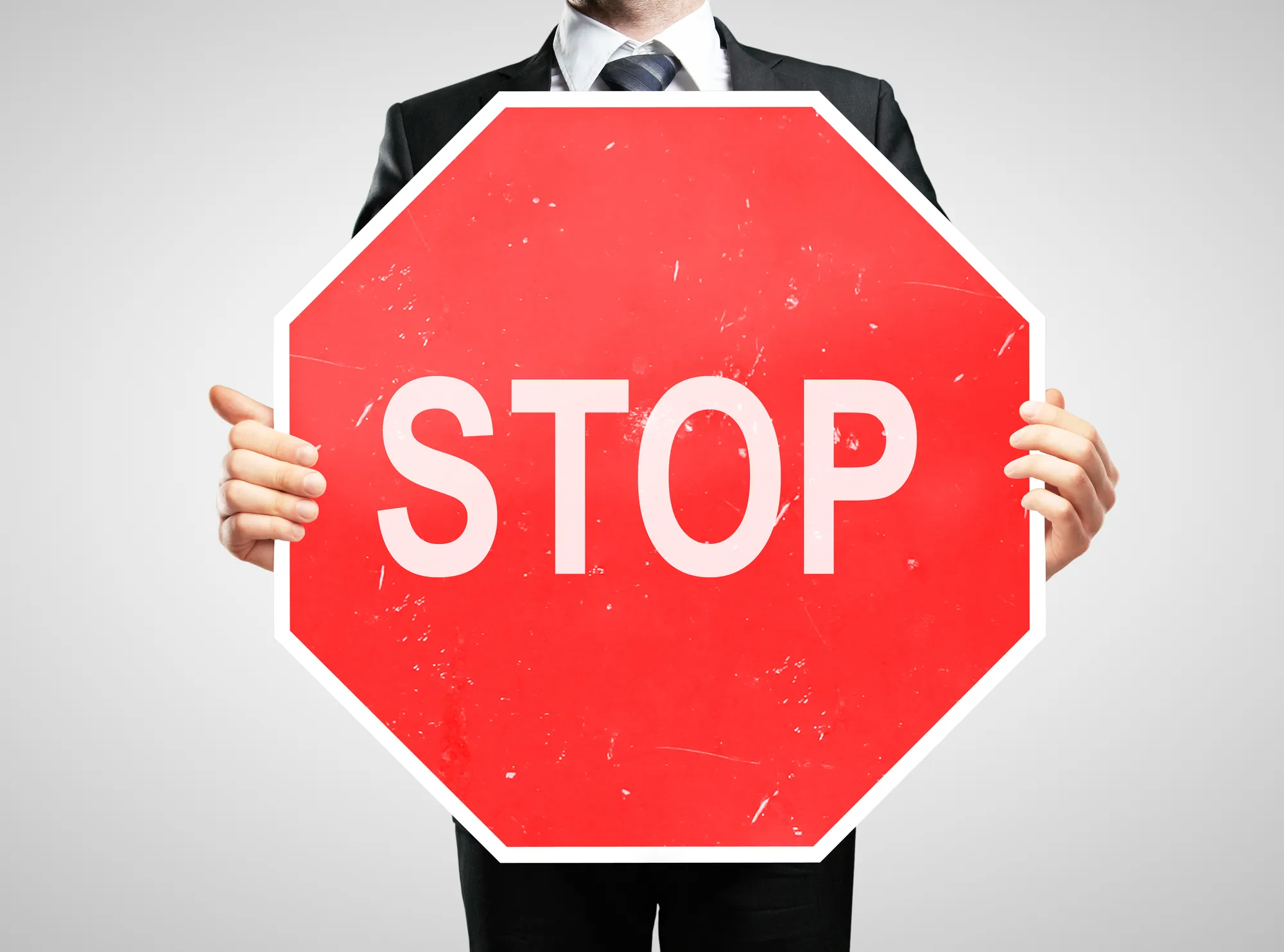 Businessman holding a stop sign