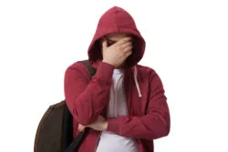 boy hiding face in hoodie