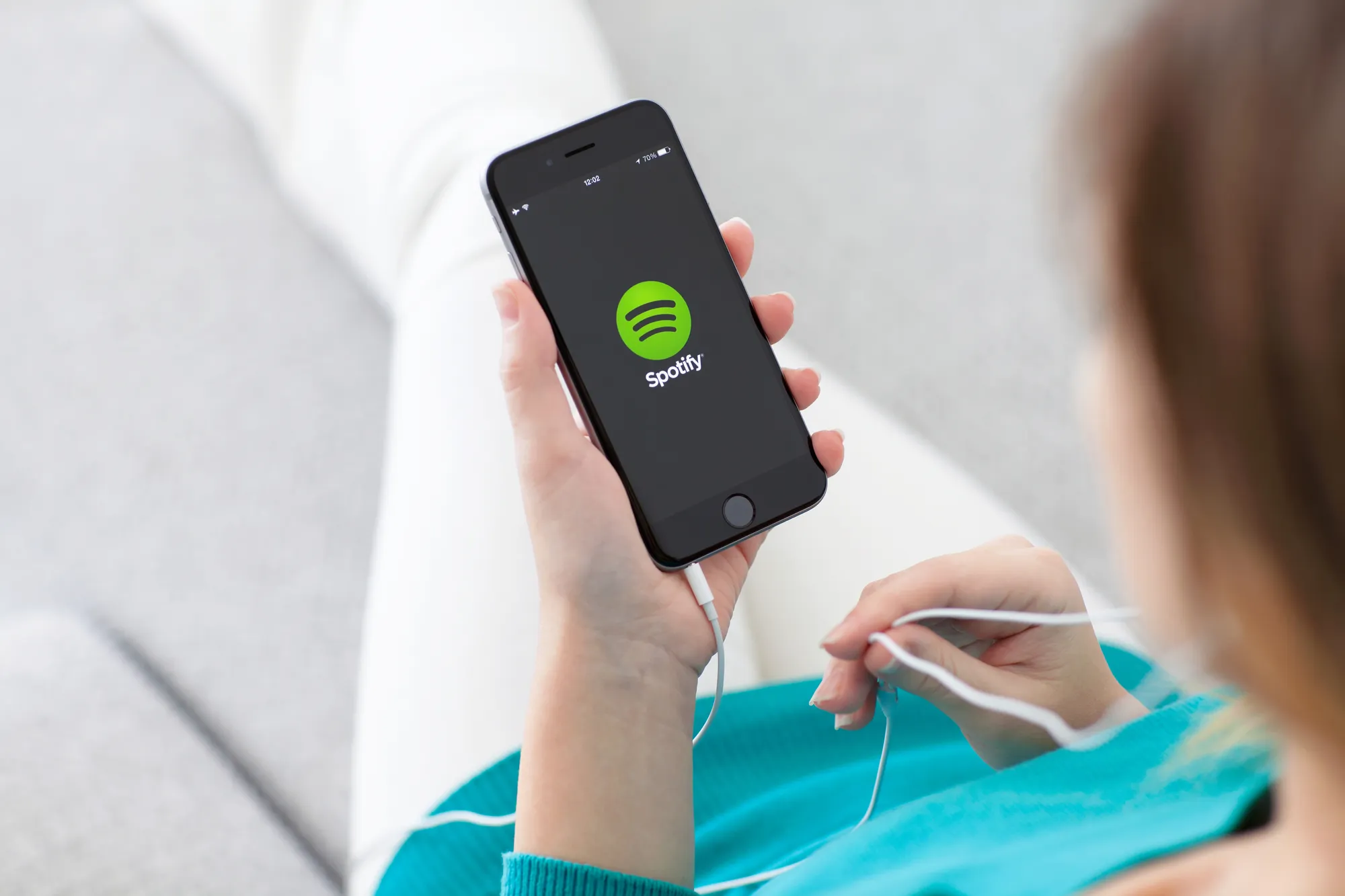Alushta, Russia - October 29, 2014: Woman holding a iPhone 6 Space Gray with music service Spotify on the screen. iPhone 6 was created and developed by the Apple inc.