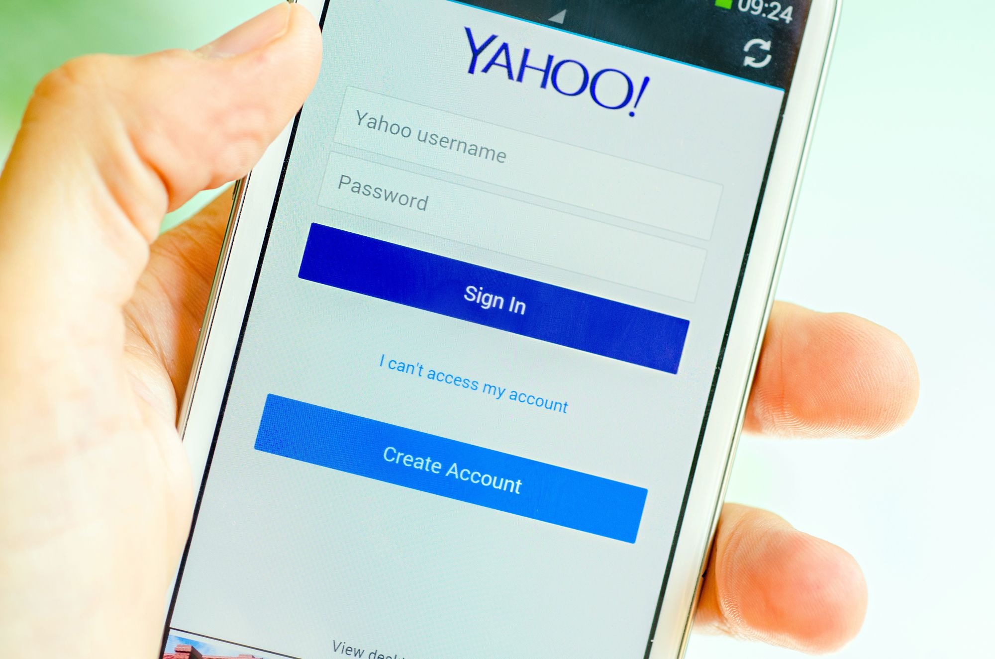LVIV, UKRAINE - May 19, 2015: Hand holding white Samsung Smart Phone with Yahoo Log In Screen