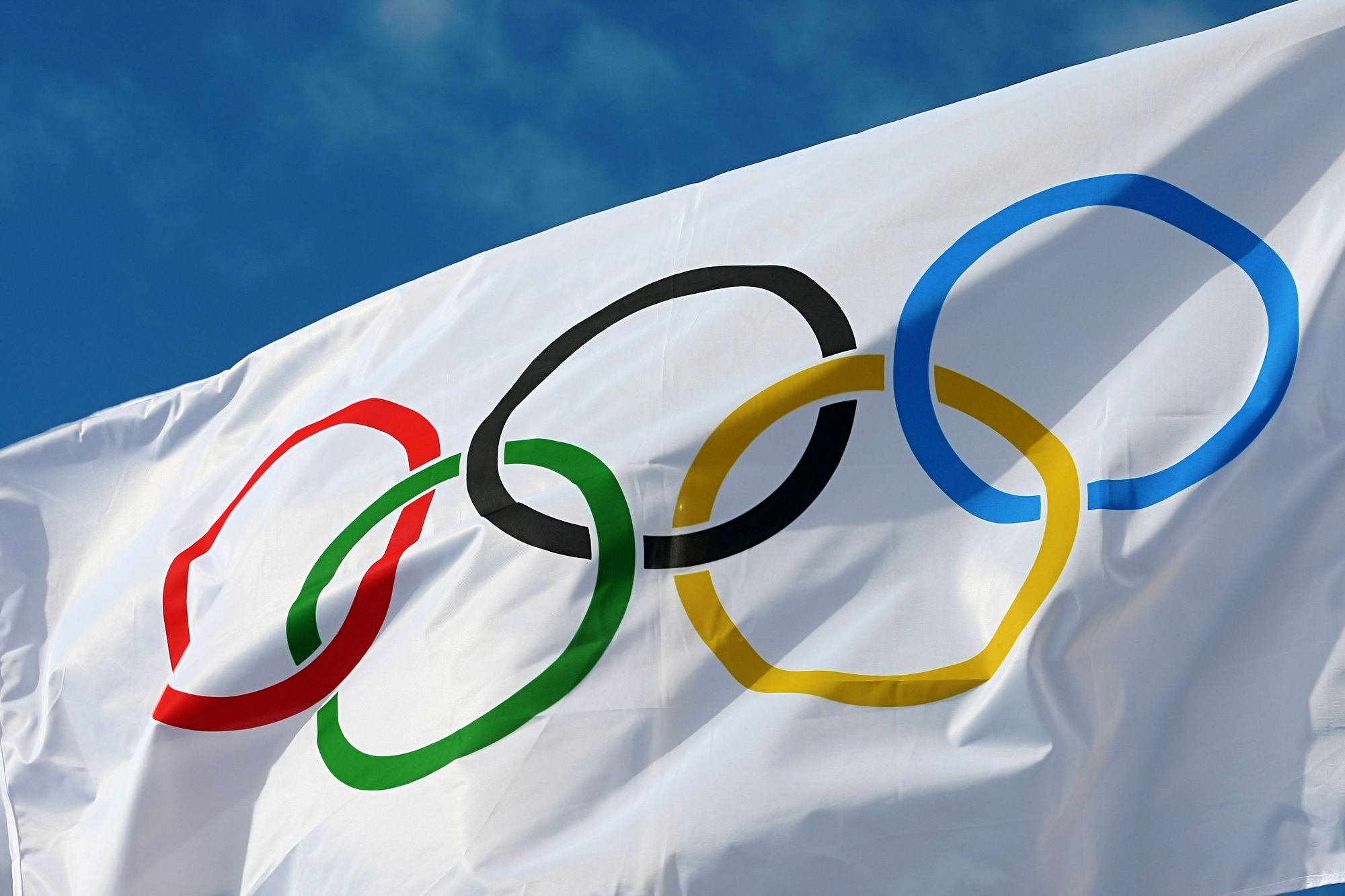 ATHENS, GREECE- OCTOBER 2, 2013: White Olympics Flag against the blue sky in Athens, Greece.