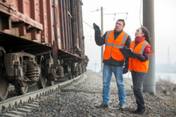 Workers at a railway inspecting train cargos