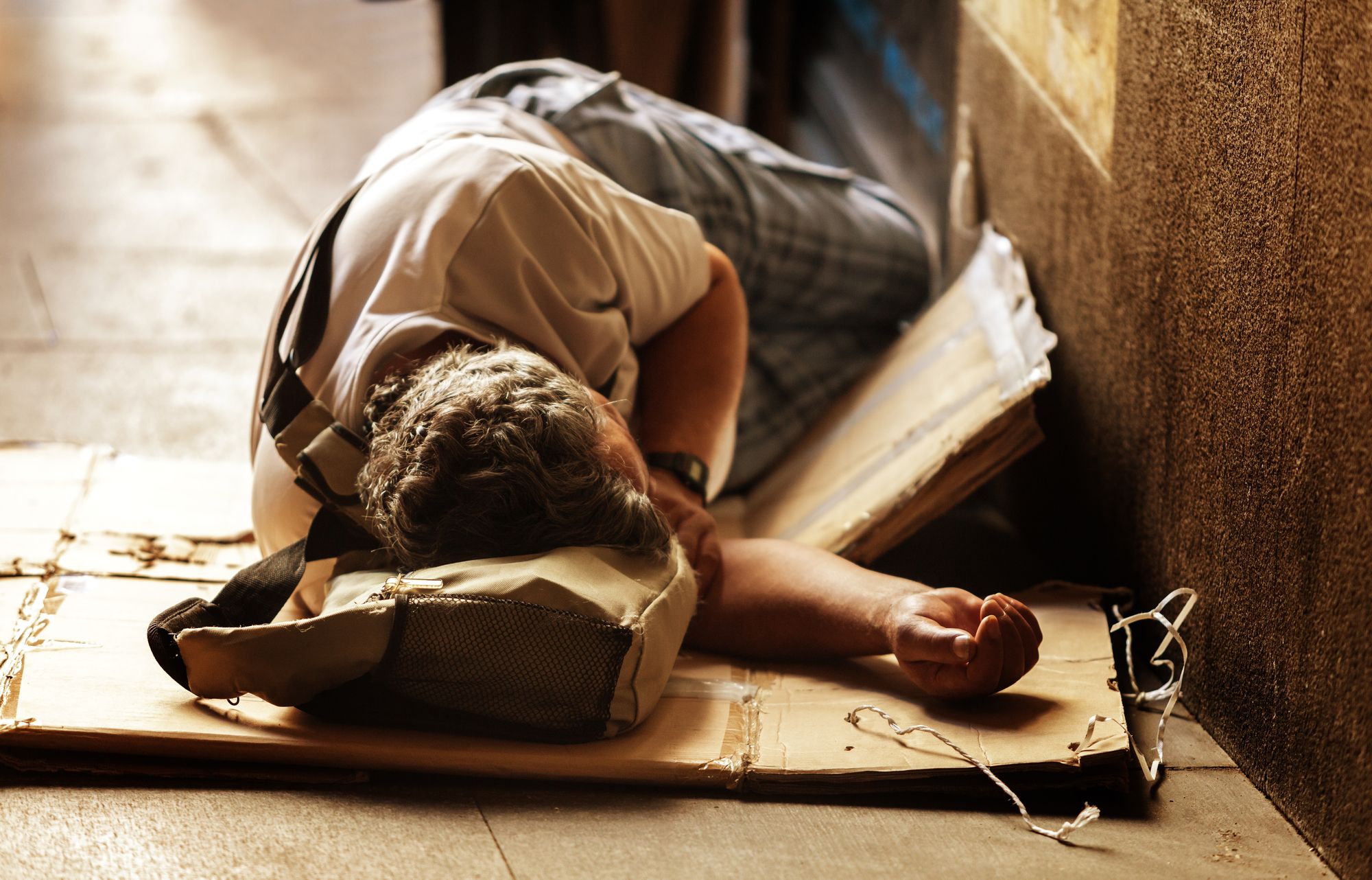 Unrecognizable Homeless Sleeping in the Floor of a Madrid street