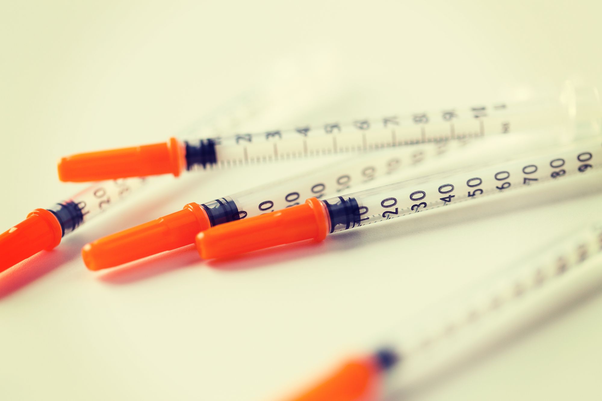 medicine, diabetes and health care concept - close up of insulin syringes on table