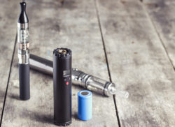 electronic cigarette on old wooden table, close up