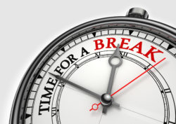 Time fora break concept clock closeup on white background with red and black words