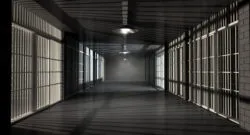 A corridor in a prison at night showing jail cells illuminted by various ominous lights