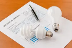 Energy efficient and incandescent bulbs on electric bill. Energy efficient house concept. selective focus