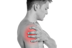 Young man having shoulder joint pain
