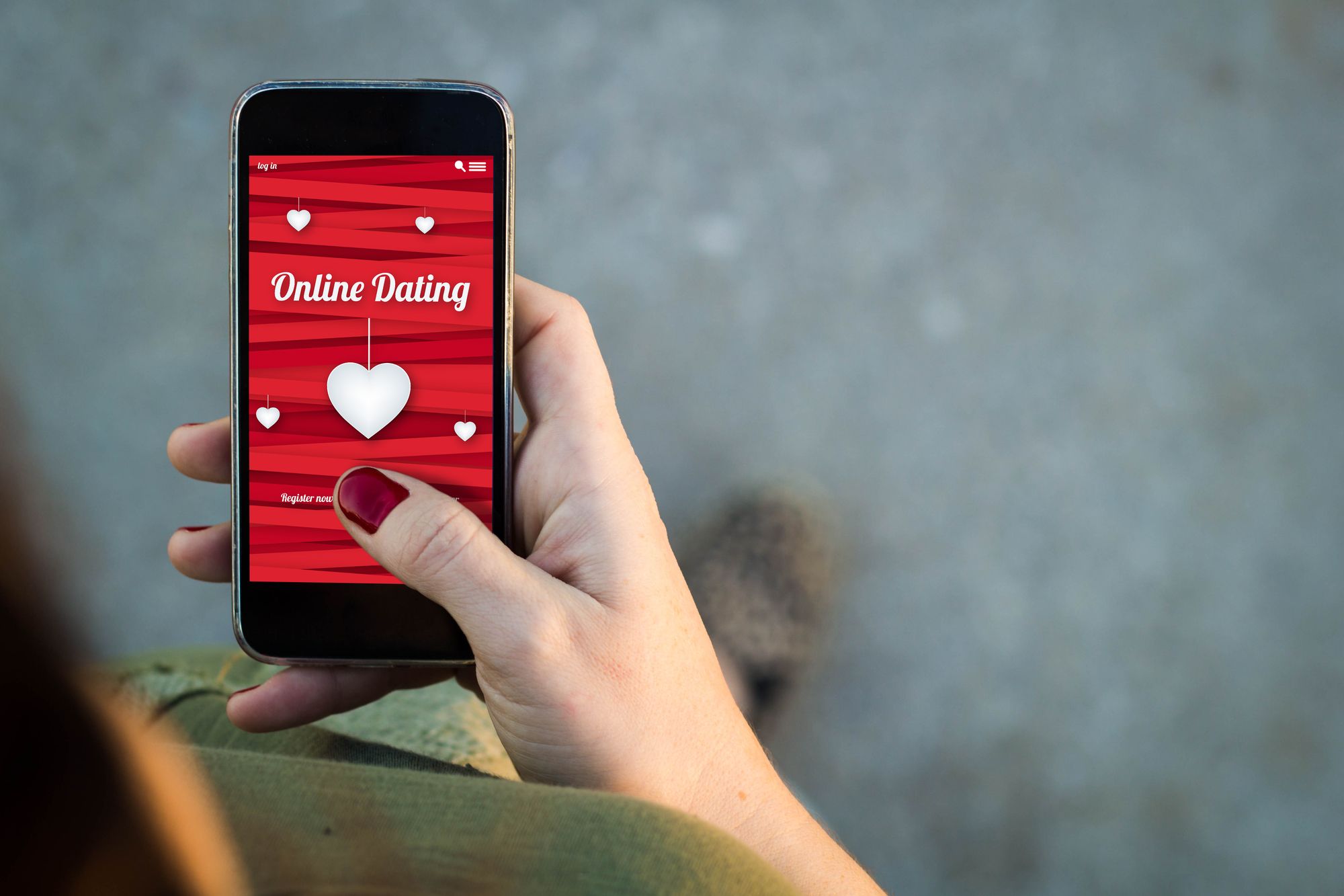 Top view of woman walking in the street using her mobile phone with online dating screen with copyspace. All screen graphics are made up.