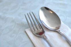 Table layout in a restaurant or hotel with utensils before a meal. Suitable for generic concepts such as food and beverage, health and dieting, dining and food catering.