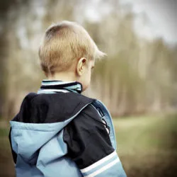 Toned Photo of Lost and Sad Little Kid stand in the Forest alone