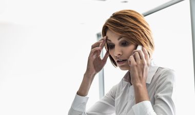 businesswoman using cell phone in office
