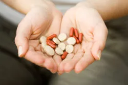 Woman holding vitamins in her hands