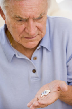 Senior Man Looking At Medicine