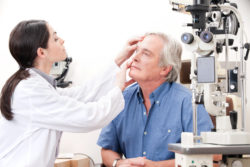 Optometrist taking an eyesight test examination.