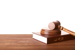 Judge gavel and book on wooden table