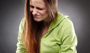 young woman w stomach pain