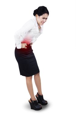Businesswoman having stomach ache