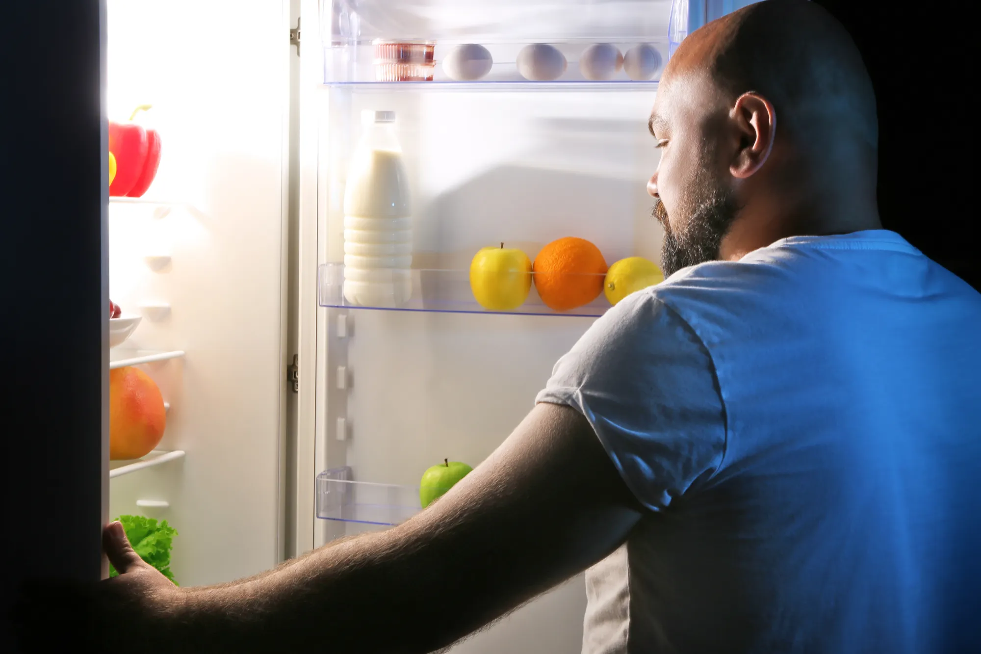 Man taking food from refrigerator